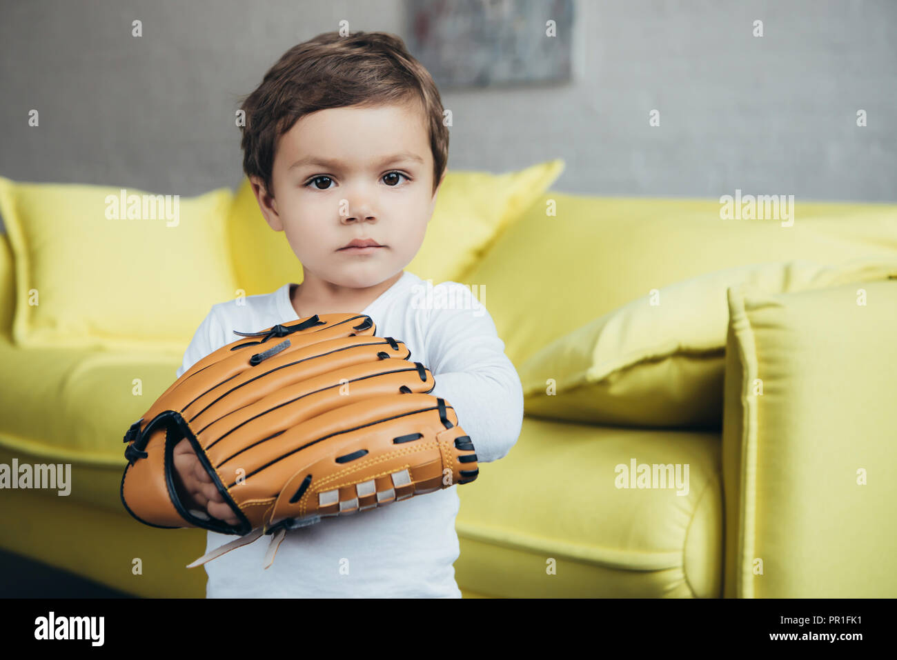 adorable little boy playing with baseball glove Stock Photo Alamy