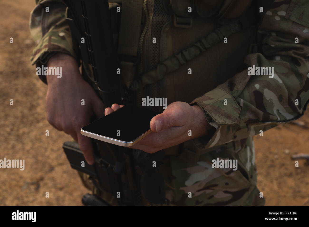 Military soldier using mobile phone during military training Stock Photo