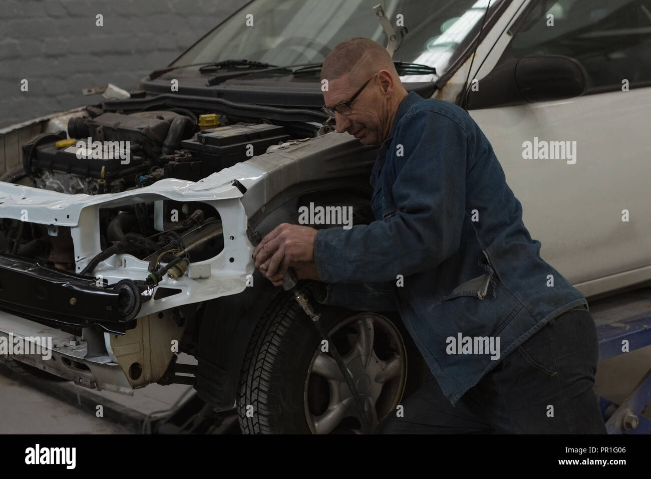 Male mechanic servicing car wheel Stock Photo