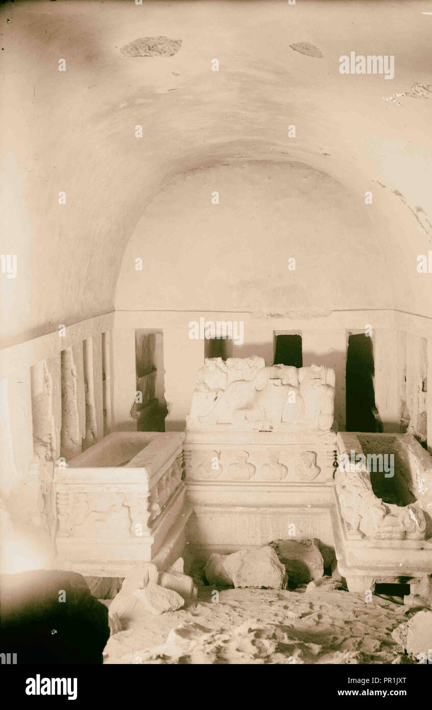 Palmyra. Tomb of the three brothers. Right hand chamber showing sarcophagi, loculi and portrait and group carvings. 1920, Syria Stock Photo