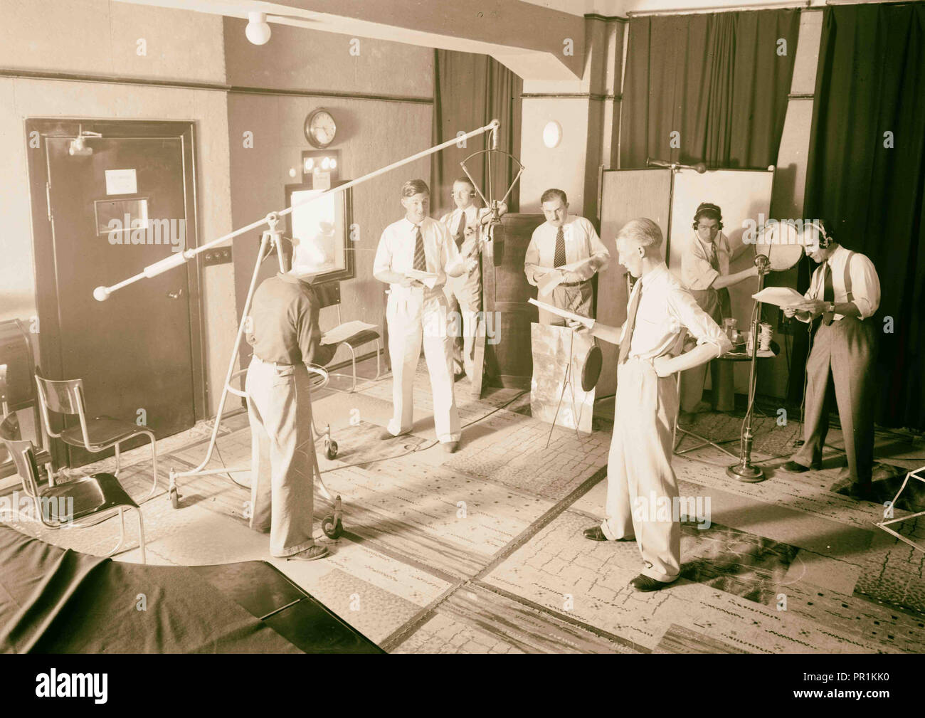 Radio studio. Group broadcasting dramatized news. 1934, Middle East, West Bank, Rām Allāh Stock Photo