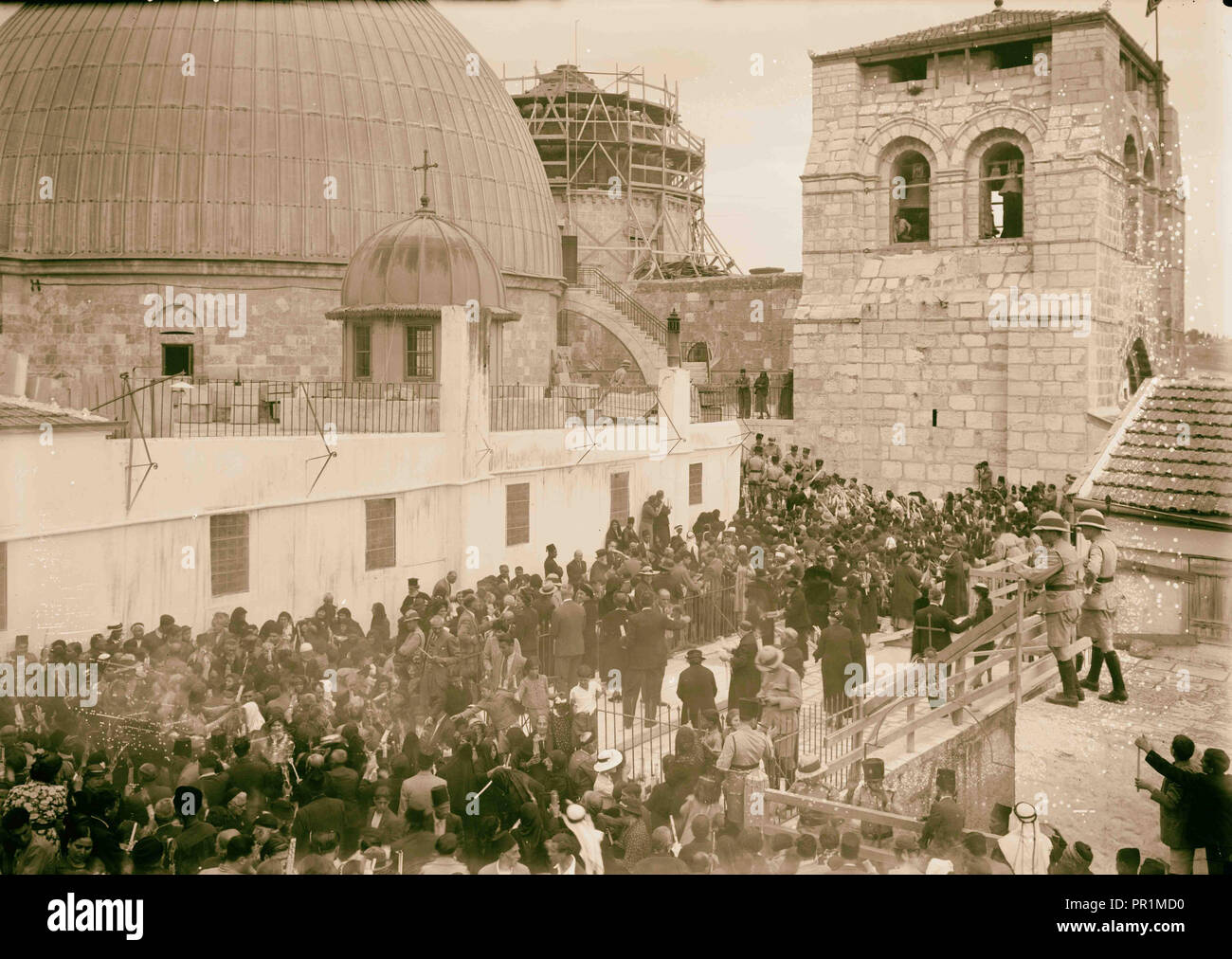 Ceremony of the Holy Fire taking place on the roof of the Greek convent showing domes of the Holy Sepulchre in the background Stock Photo