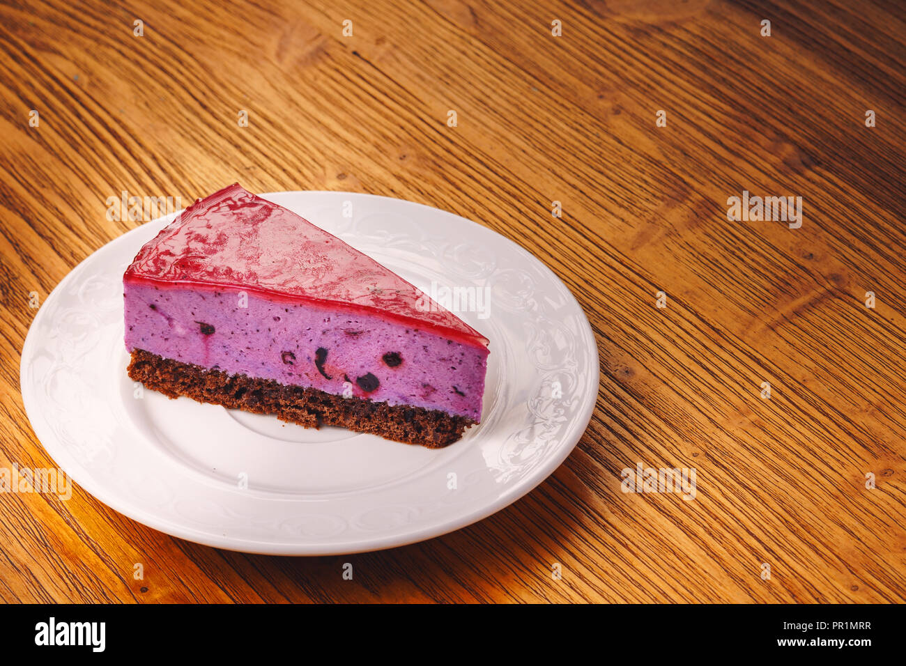 Delicious piece of  blueberry cake on the wooden table Stock Photo