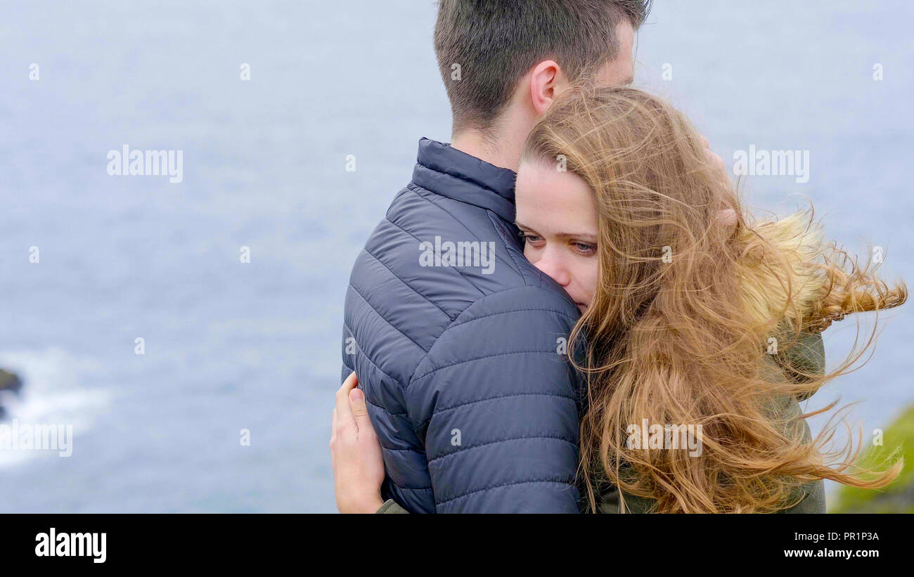Young Guy Hugs His Girlfriend And Give Her Comfort Stock Photo