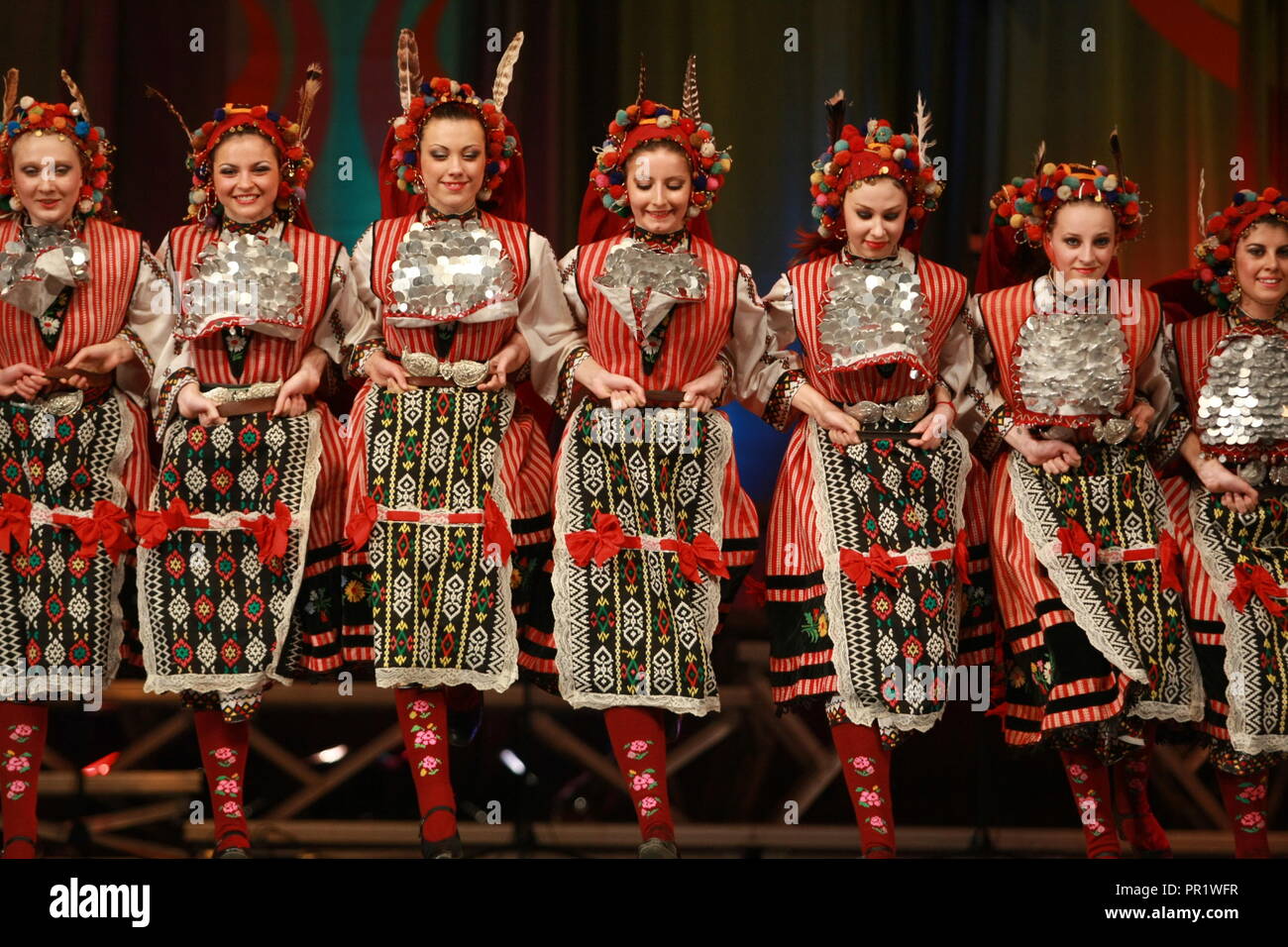 People in traditional folklore costumes perform folk dance bulgarian horo on National folklore fair in the Sofia, Stock Photo