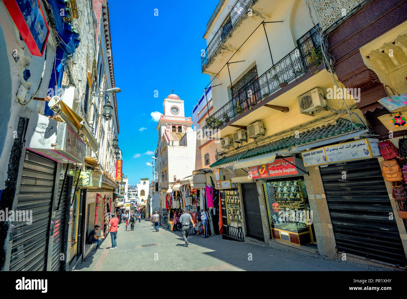 Shopping street in medina with view of mosque at old town Tangier. Morocco, North Africa Stock Photo