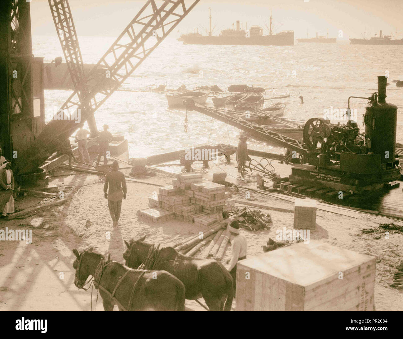 Construction of Jaffa pier. Cranes at work on the Jaffa docks. Unusual back lighting effect. 1934, Israel, Tel Aviv Stock Photo