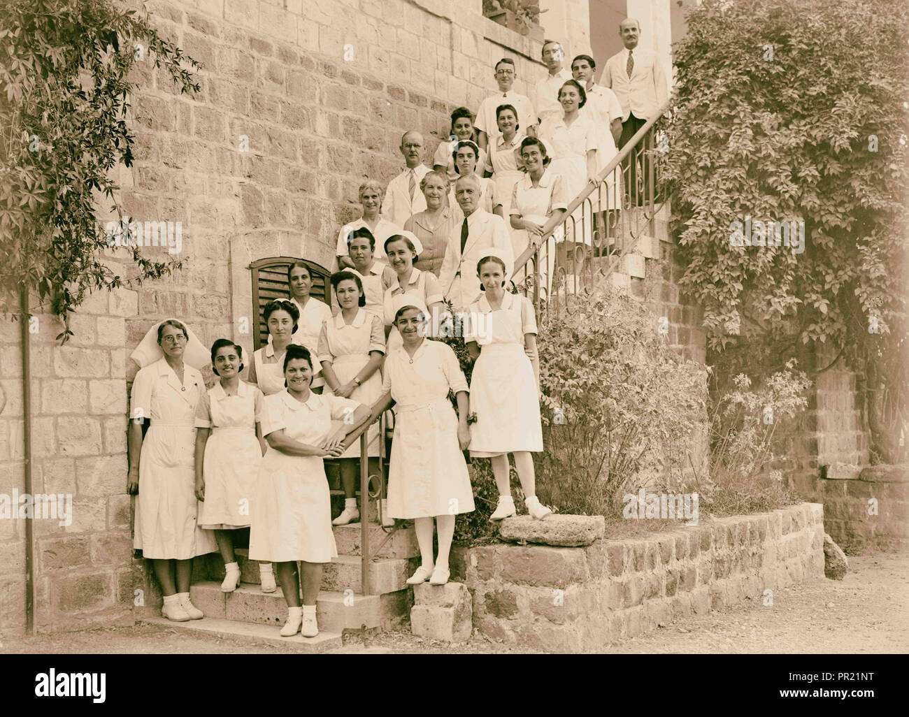 Dr. H. Torrance, Tiberias. Group. Staff on the steps of the doctor's house. 1940, Israel, Tiberias Stock Photo