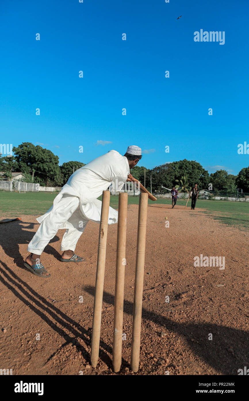 Young men playing social cricket game in Trincomalee, Sri Lanka Stock Photo