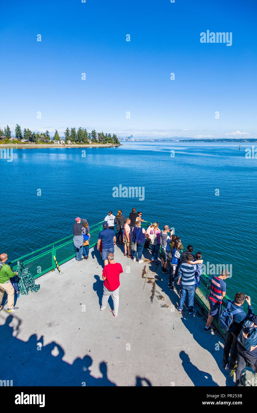 People on bow of Bainbridge Island to Seattle Ferry in Puget Sound in Washington, United States Stock Photo