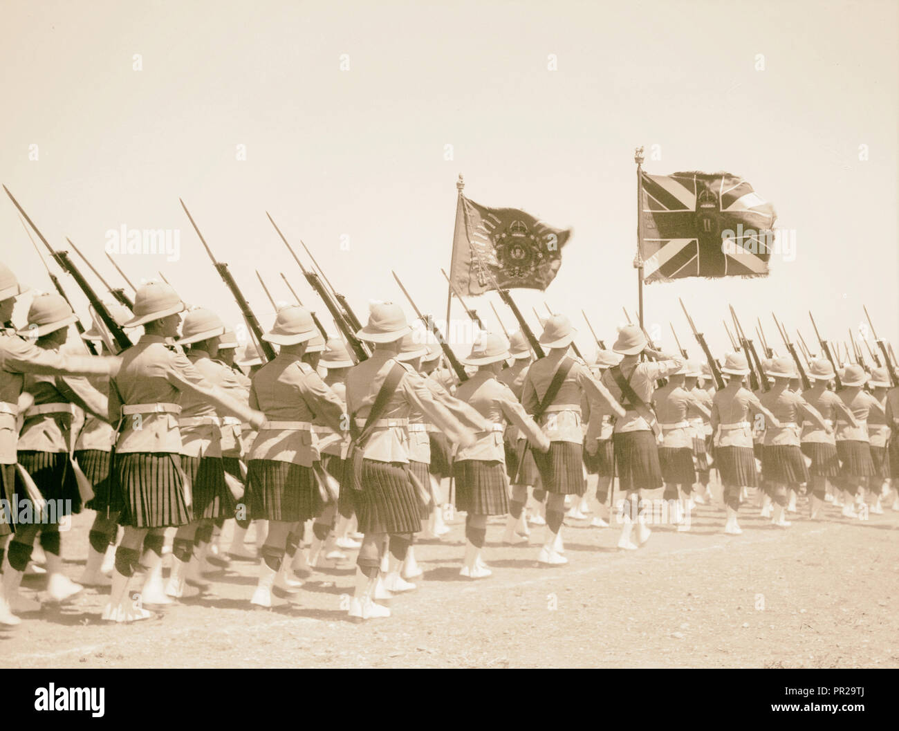 King's birthday celebration Scotch, Scots regiment with the National Standard and their regimental colours 1936, Middle East Stock Photo