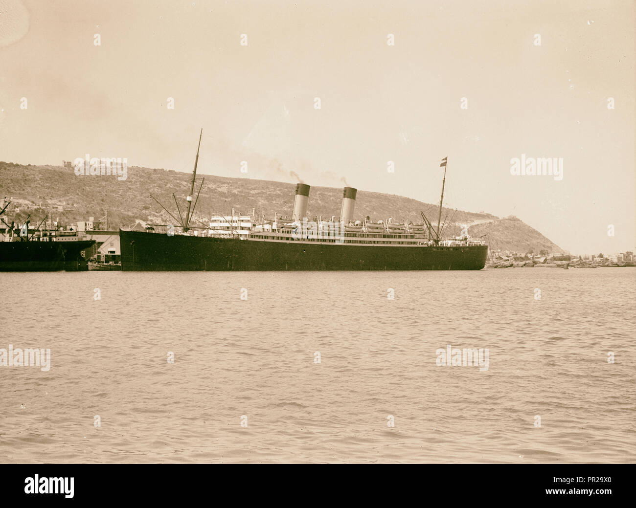 Palestine disturbances 1936. The luxury liner Laurentic docked in Haifa. Mt. Carmel is conspicuously seen in the background Stock Photo