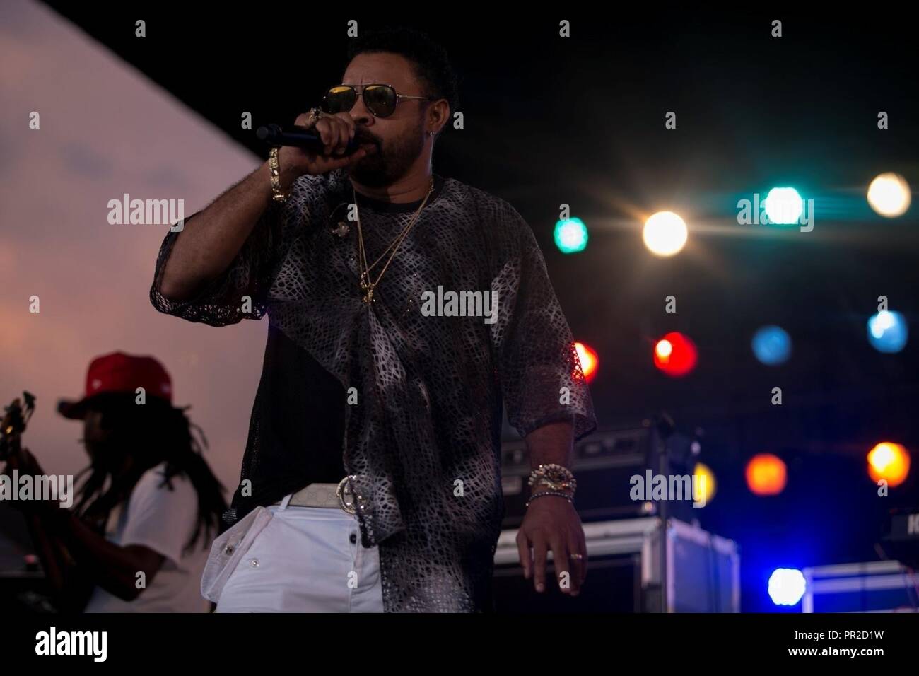CAMP HANSEN, OKINAWA, Japan – Shaggy sings during a concert July 22 aboard Camp Hansen, Okinawa, Japan. The free concert was open to military and local communities. Shaggy, a former field artillery cannon crewmember for the Marine Corps, is now a Jamaican-American reggae fusion singer and DJ. Stock Photo