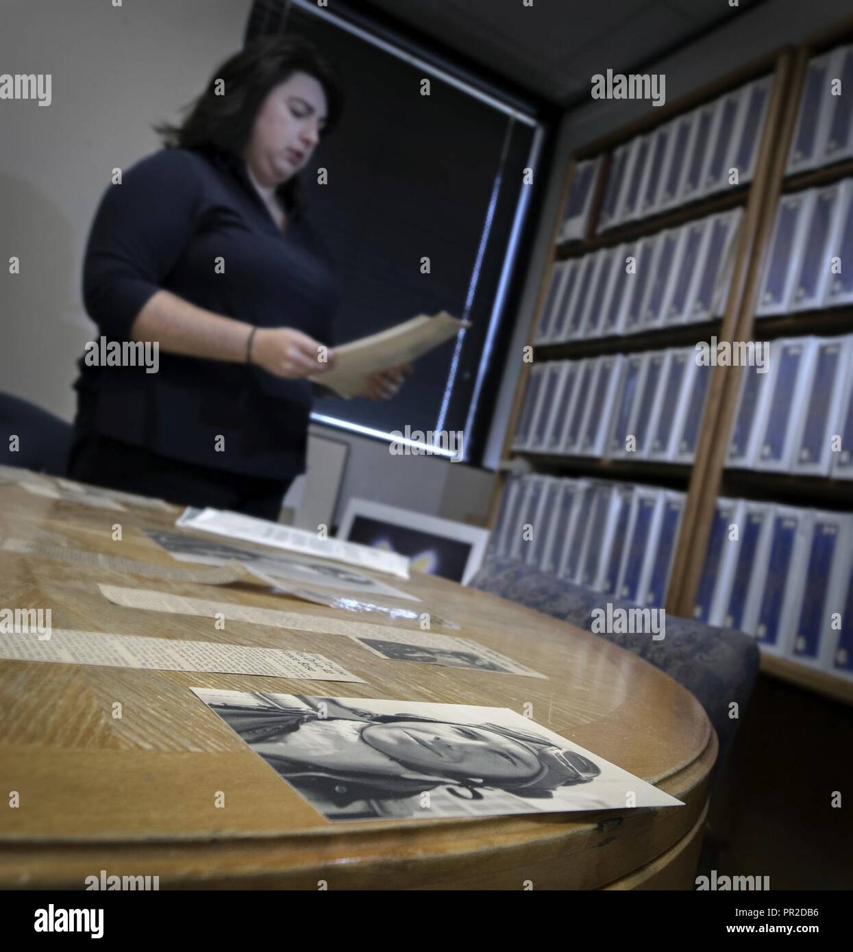 Wing historian Stephanie Ritter pieces together a layout for a future display at Vance Air Force Base, Oklahoma, July 24. The historian's office is home to thousands of artifacts and records covering Vance's wide-ranging pilot training story. Stock Photo