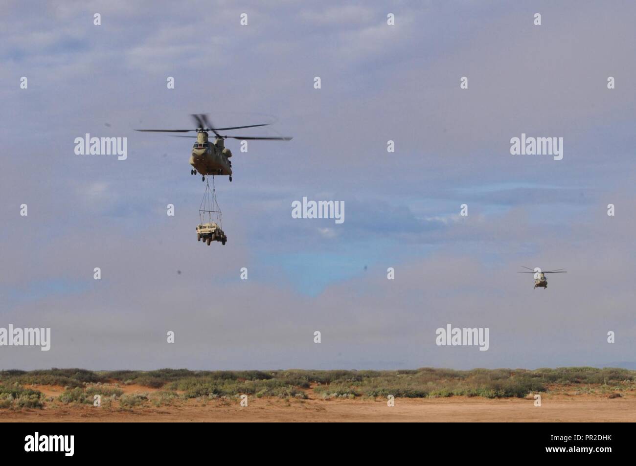 CH-47 Chinook transports a HUMVEE during a sling load operation as part ...