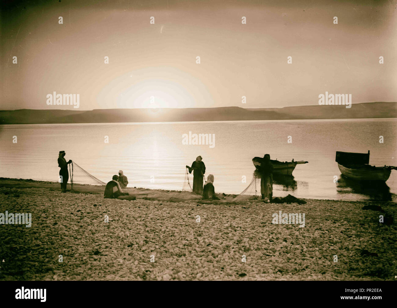 Choice set of thirteen slides, illustrating the Sea of Galilee and its fishermen still 'toiling with their nets.' Mending nets Stock Photo
