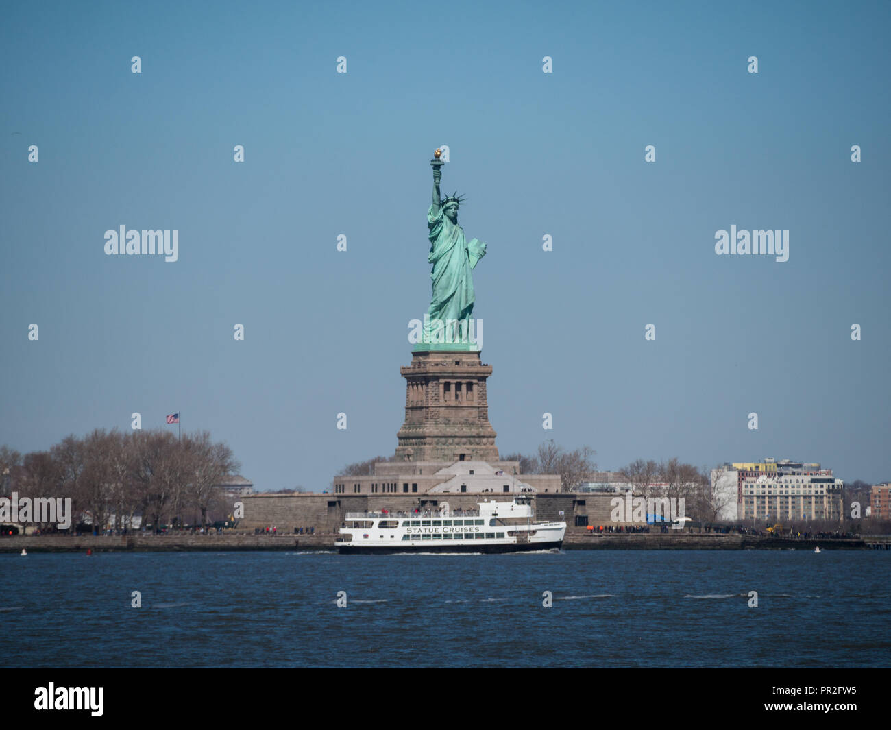 Tourist ferry in front of the Statue of Liberty Stock Photo