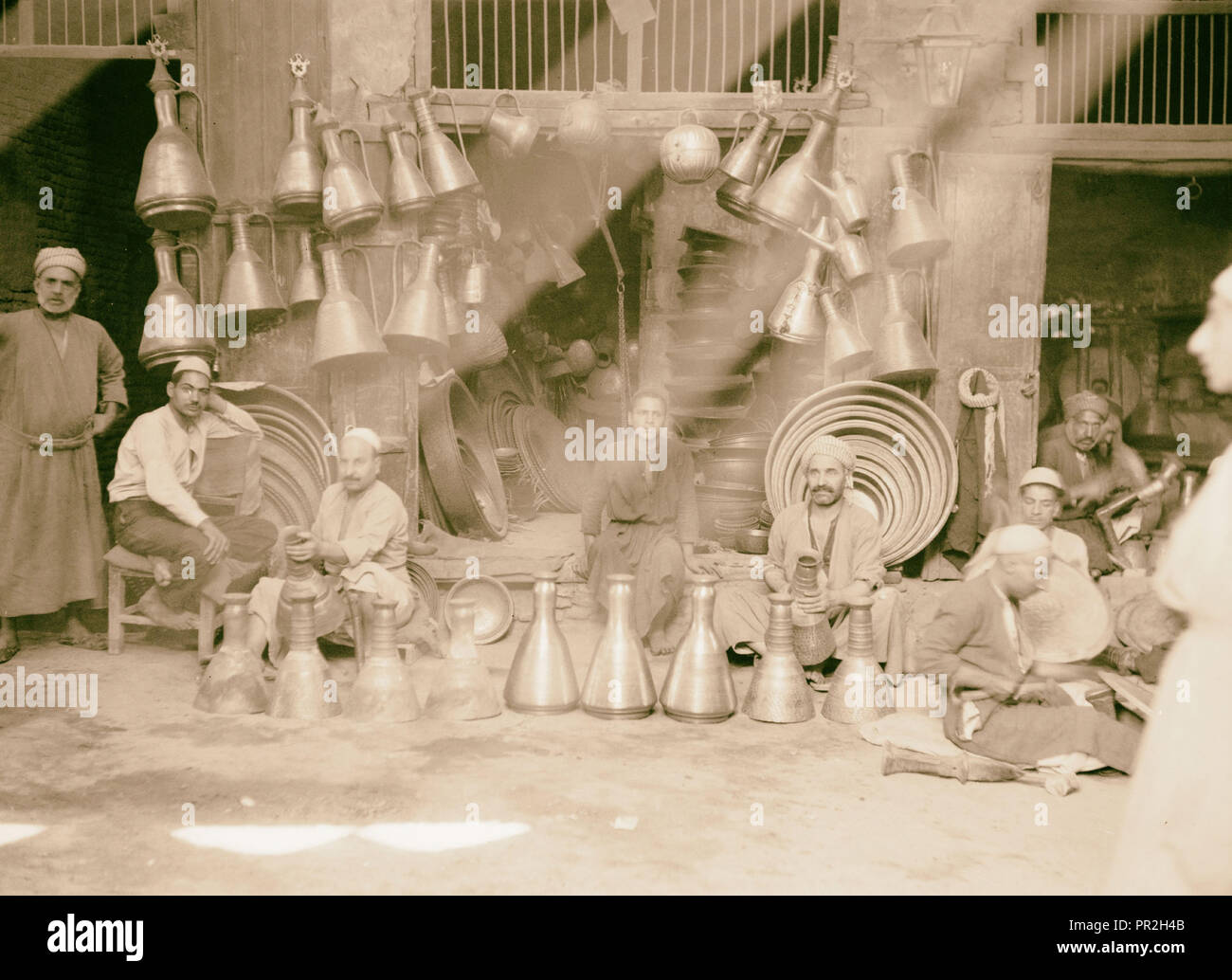 Iraq. (Mesopotamia). Baghdad. Views, street scenes, and types. Typical copper store with jugs and trays. 1932, Iraq, Baghdad Stock Photo