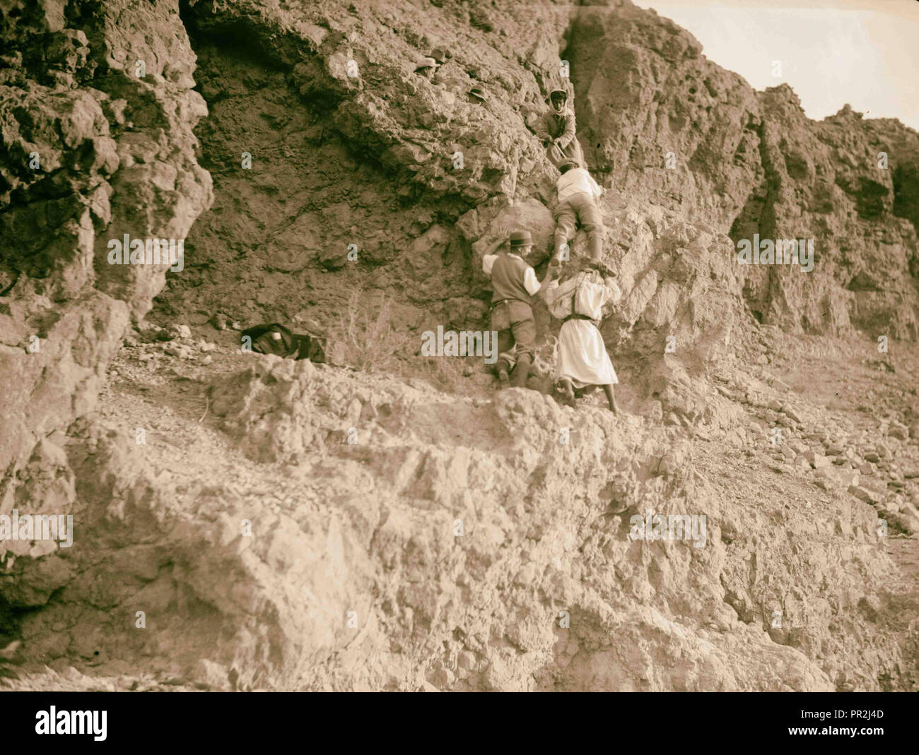 Motor boat trip around the Dead Sea. Scaling Masada's topmost cliffs. The climb above the ramp. 1920, Israel, Masada Site Stock Photo