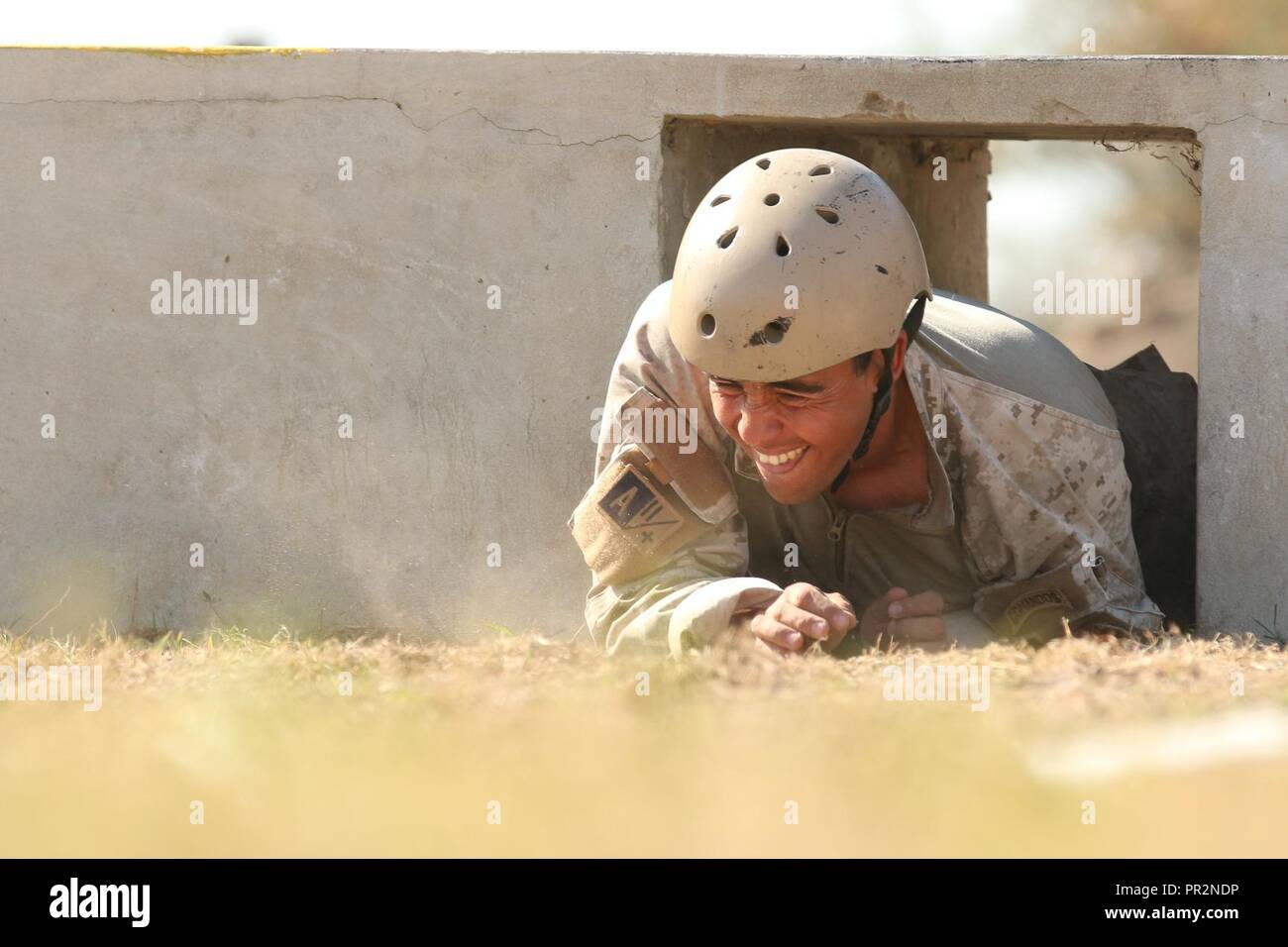 A Chilean competitor crawls through an obstacle July 24, 2017, during Fuerzas Comando in Vista Alegre, Paraguay. Throughout Fuerzas Comando, competitors' physical limits and marksmanship expertise are tested in hopes to increase their tactical skills. Stock Photo
