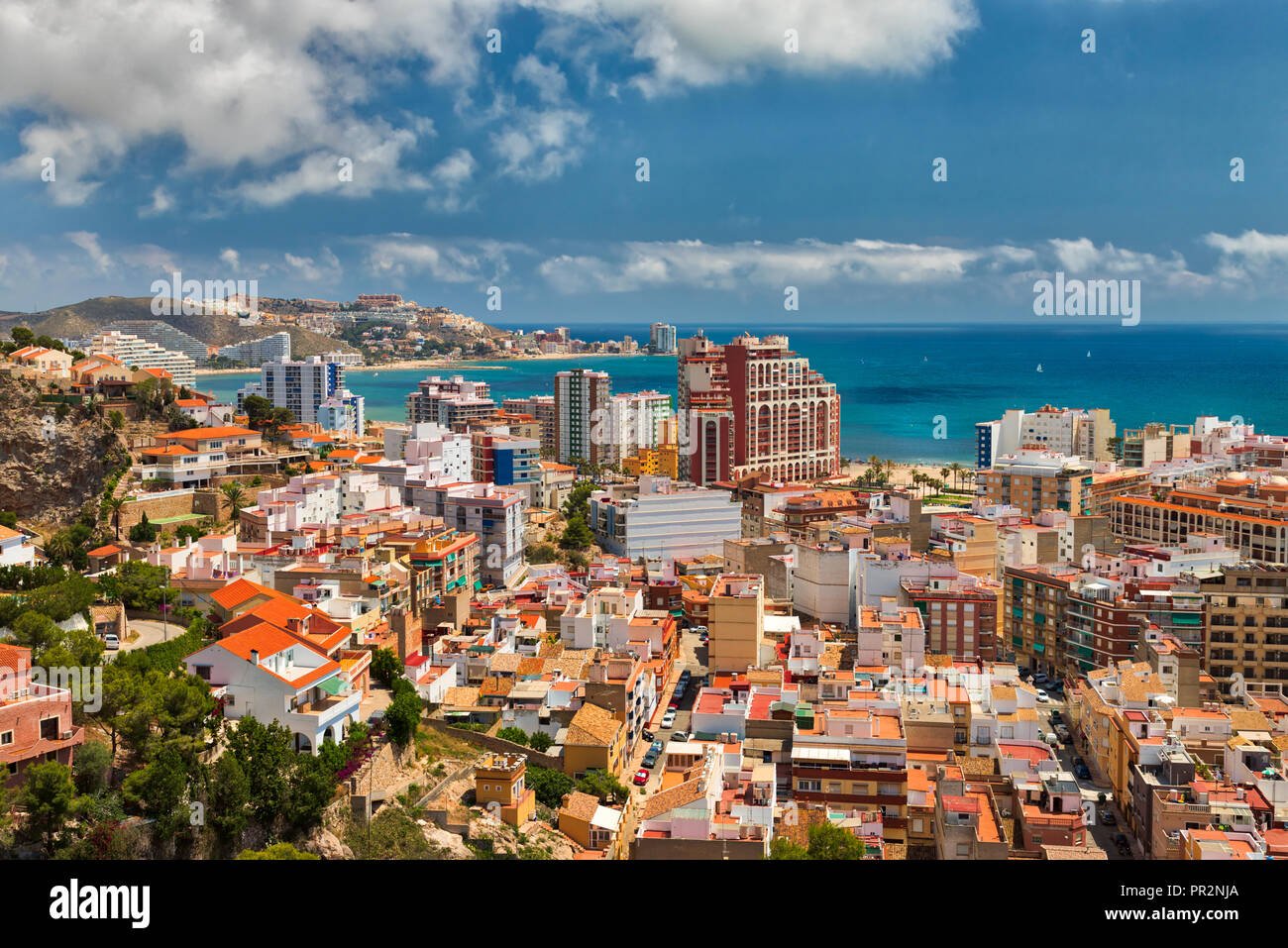 Beautiful above view of the vacation area of Cullera, Spain, showing the city and the coastline with a bright blue sky and white clouds Stock Photo