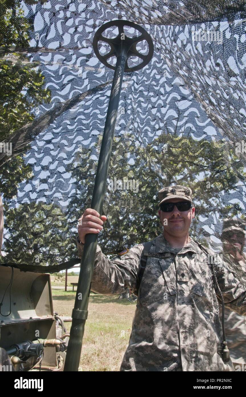 spc-sam-dehaven-a-us-army-reserve-medic-and-civilian-commercial-window-installer-with-the-844th-hhc-engineer-battalion-411th-engineer-brigade-412th-theater-engineer-command-sets-up-camo-netting-at-the-844ths-familiarize-fire-for-the-new-m320-40mm-grenade-launcher-during-river-assault-2017-at-fort-chaffee-maneuver-center-ark-july-24-2017-river-assault-2017-is-a-two-week-extended-combat-training-exercise-held-july-15-28-focusing-on-technical-skills-of-various-service-members-culminating-with-the-construction-of-a-floating-improved-ribbon-bridge-across-the-arkansas-river-PR2NXC.jpg