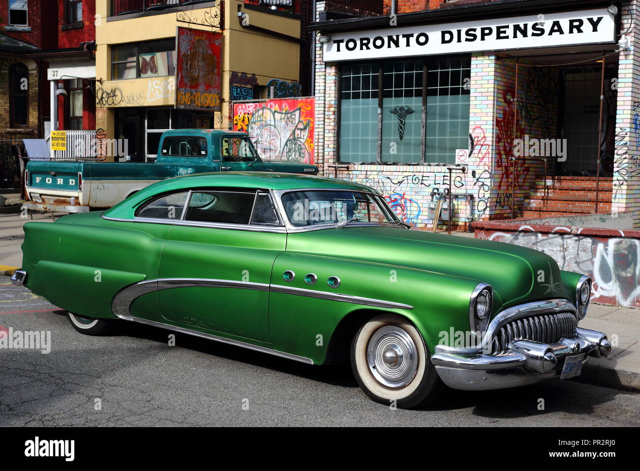Green Buick Super parked in front of the Toronto Dispensary at Kensington Market, Toronto, CA. Stock Photo