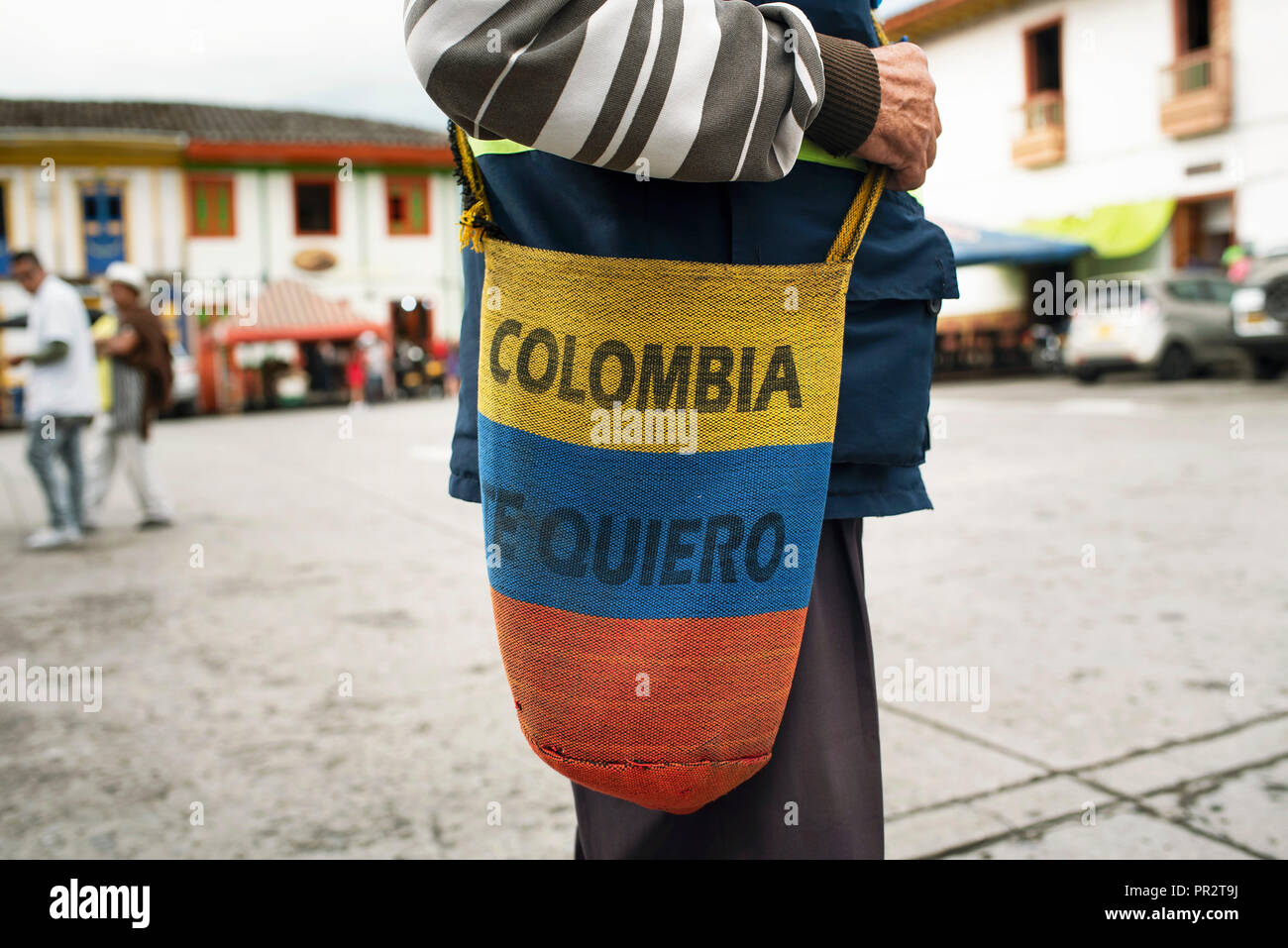 Colombian artisan bag worn by a patriotic local man. Handcrafted mochilla with national colours. Salento, Colombia. Sep 2018 Stock Photo