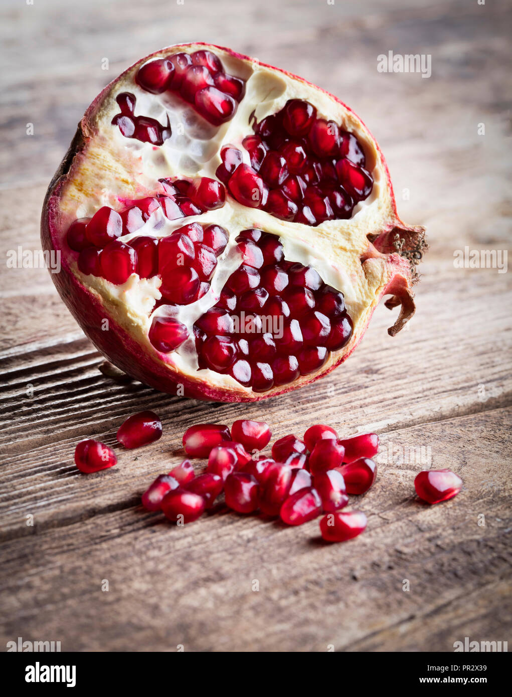 piece of pomegranate on wooden background Stock Photo
