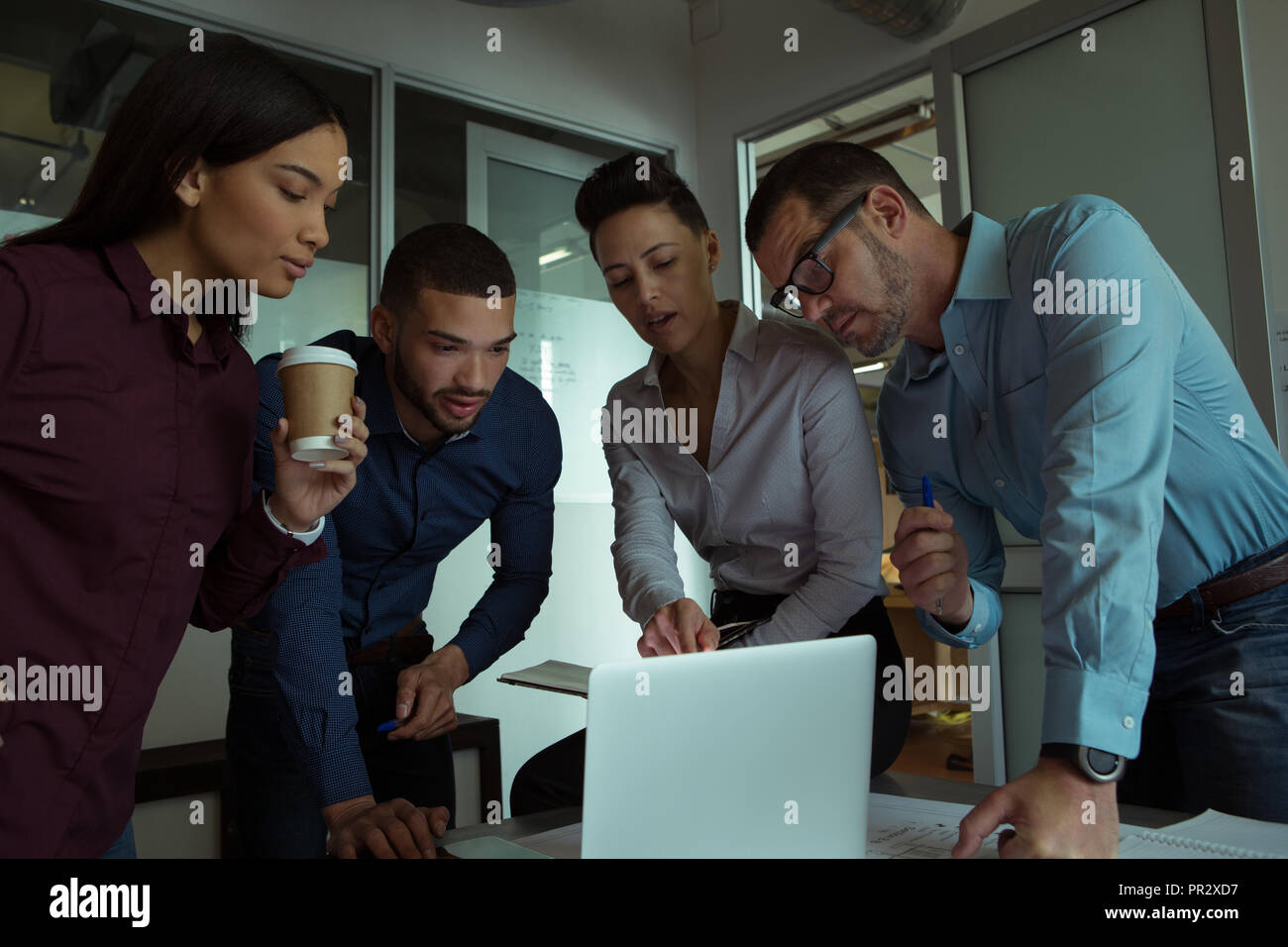 Executives discussing over laptop Stock Photo