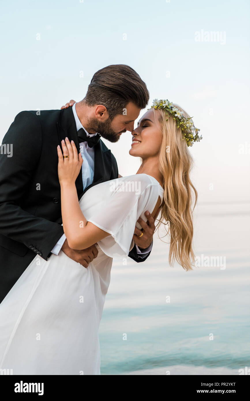 https://c8.alamy.com/comp/PR2YKT/affectionate-romantic-wedding-couple-going-to-kiss-on-beach-PR2YKT.jpg