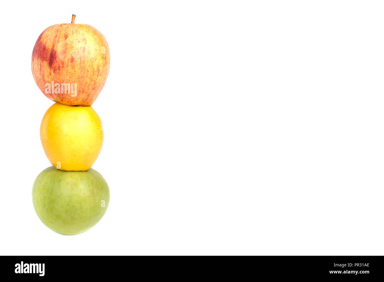 Tower of a red, yellow and green apple in the form of a sphere on a white (isolated) background Stock Photo