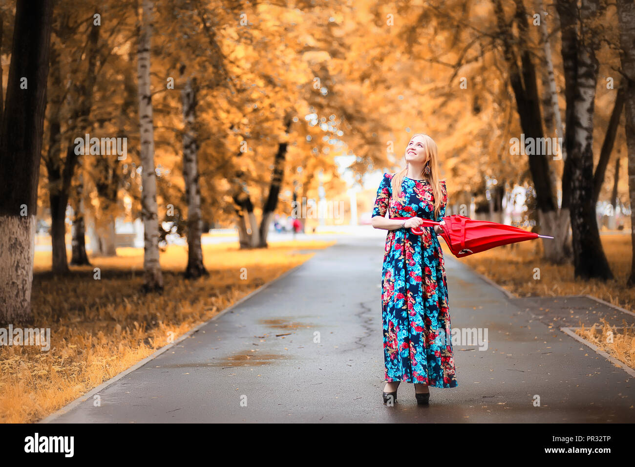 Girl in the street with an umbrella Stock Photo - Alamy