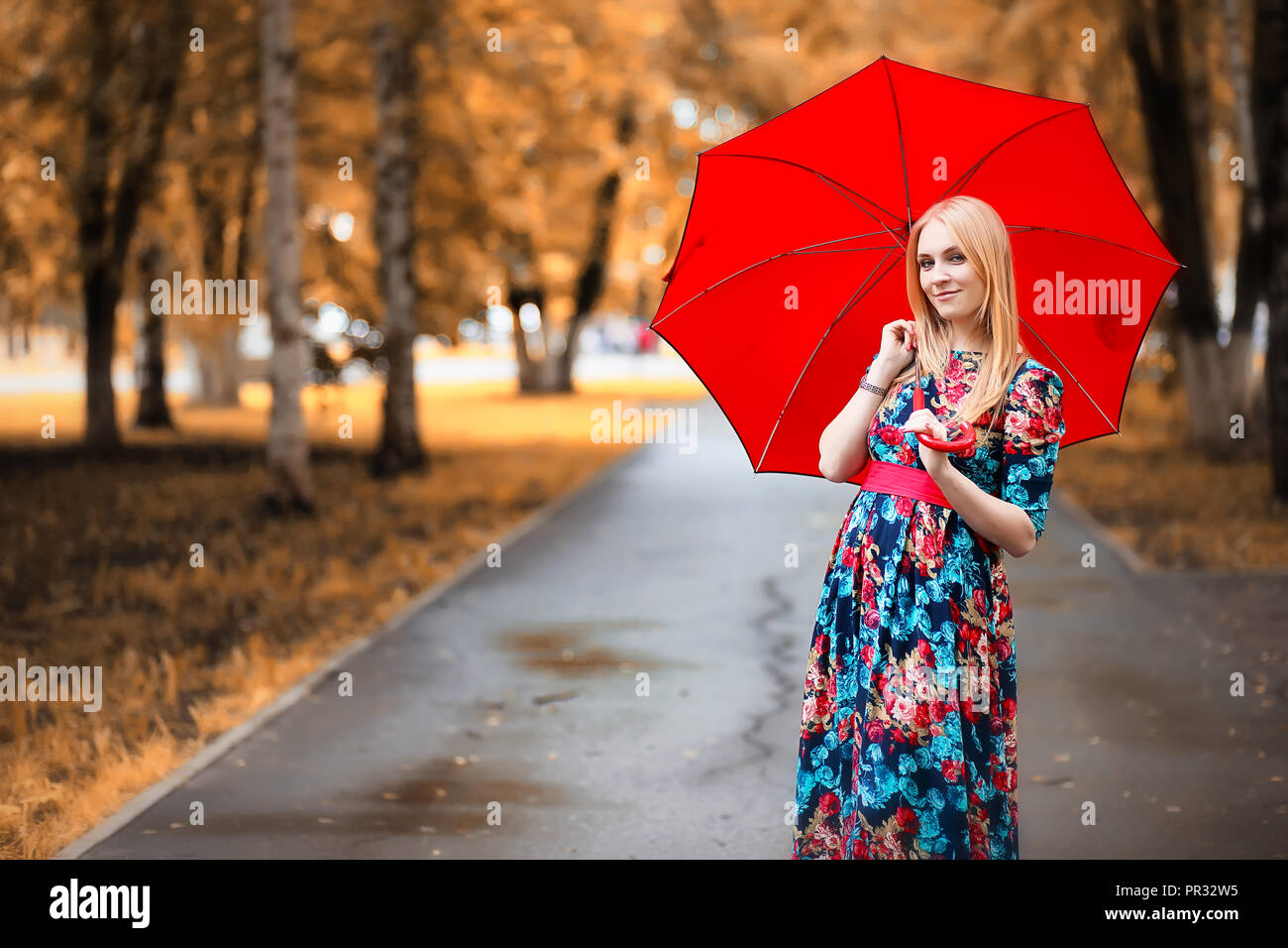 Girl in the street with an umbrella Stock Photo - Alamy