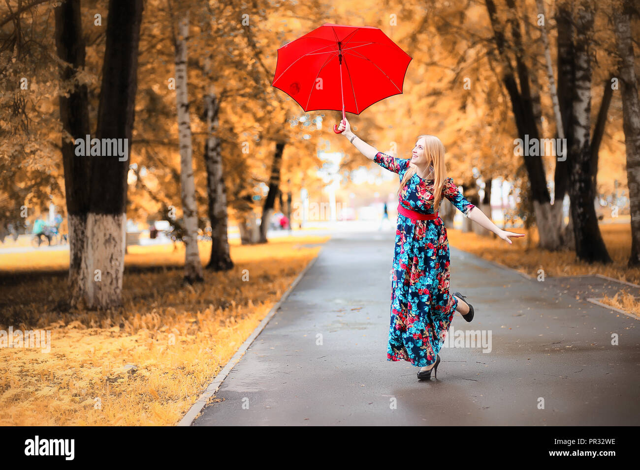 Girl in the street with an umbrella Stock Photo - Alamy