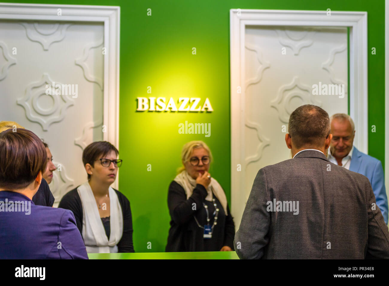 BOLOGNA (ITALY), SEPTEMBER 28, 2018: booth presenters informing visitors at CERSAIE, international exhibition of ceramic tile and bathroom furnishings Stock Photo