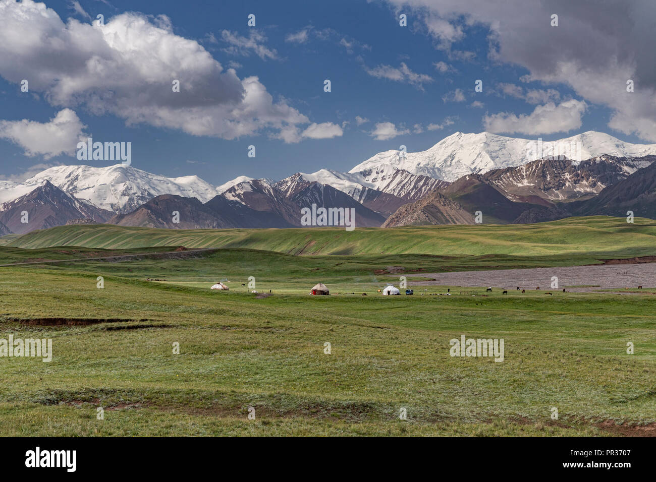 Beautifully located in the Alay Valley between the Zaalay Mountains and the Pamir, the Pamir Highway descends into Kyrgyzstan. Stock Photo