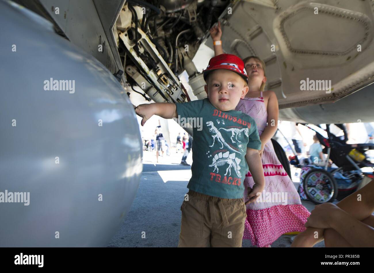 A child touches an aircraft during SkyFest 2017 Air Show and Open House at Fairchild Air Force Base, Washington, July 30, 2017. SkyFest was hosted  to thank the local and regional community for their support and give them the opportunity to meet Airmen and learn about the Air Force mission. Stock Photo