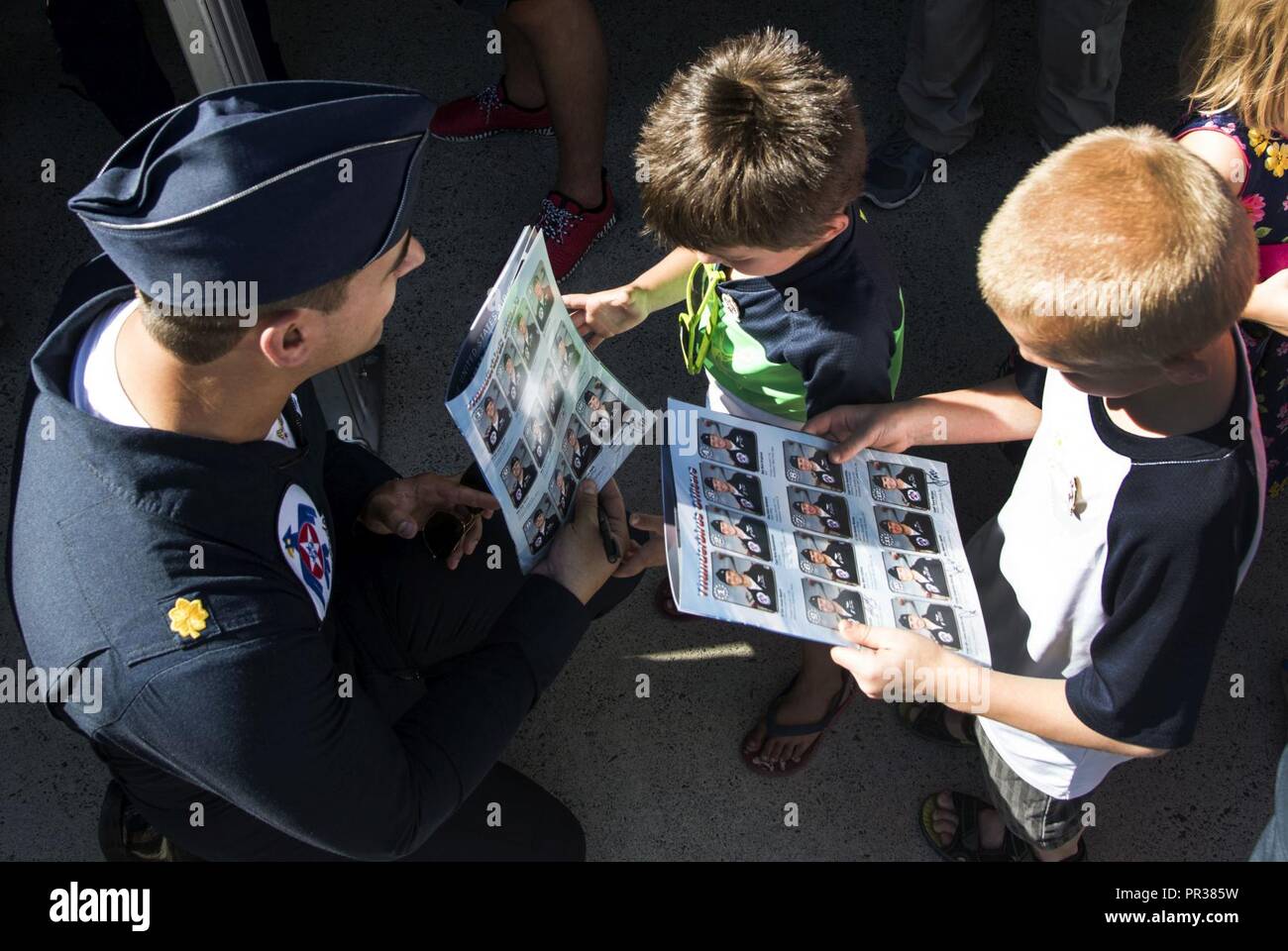 Maj. Whit Collins, U.S. Air Force Aerial Demonstration Squadron “Thunderbirds” pilot #6 signs autographs for the local and regional community during SkyFest 2017 Air Show and Open House at Fairchild Air Force Base, Washington, July 28, 2017. SkyFest was an opportunity to give the local and regional community a chance to view Airmen and our resources. Stock Photo
