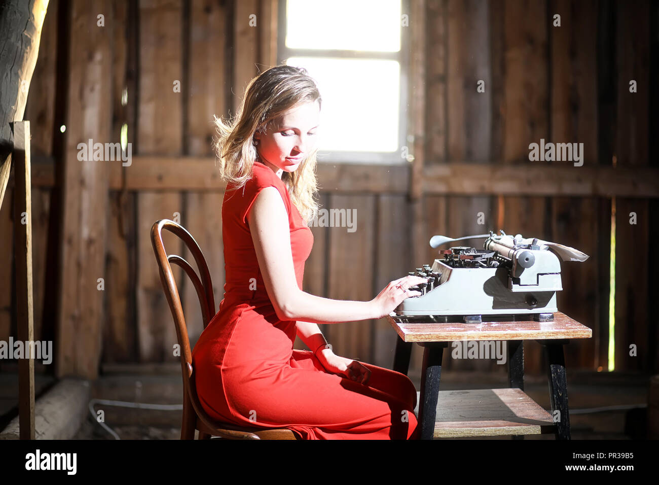 A girl in retro style prints on an old typewriter Stock Photo Alamy