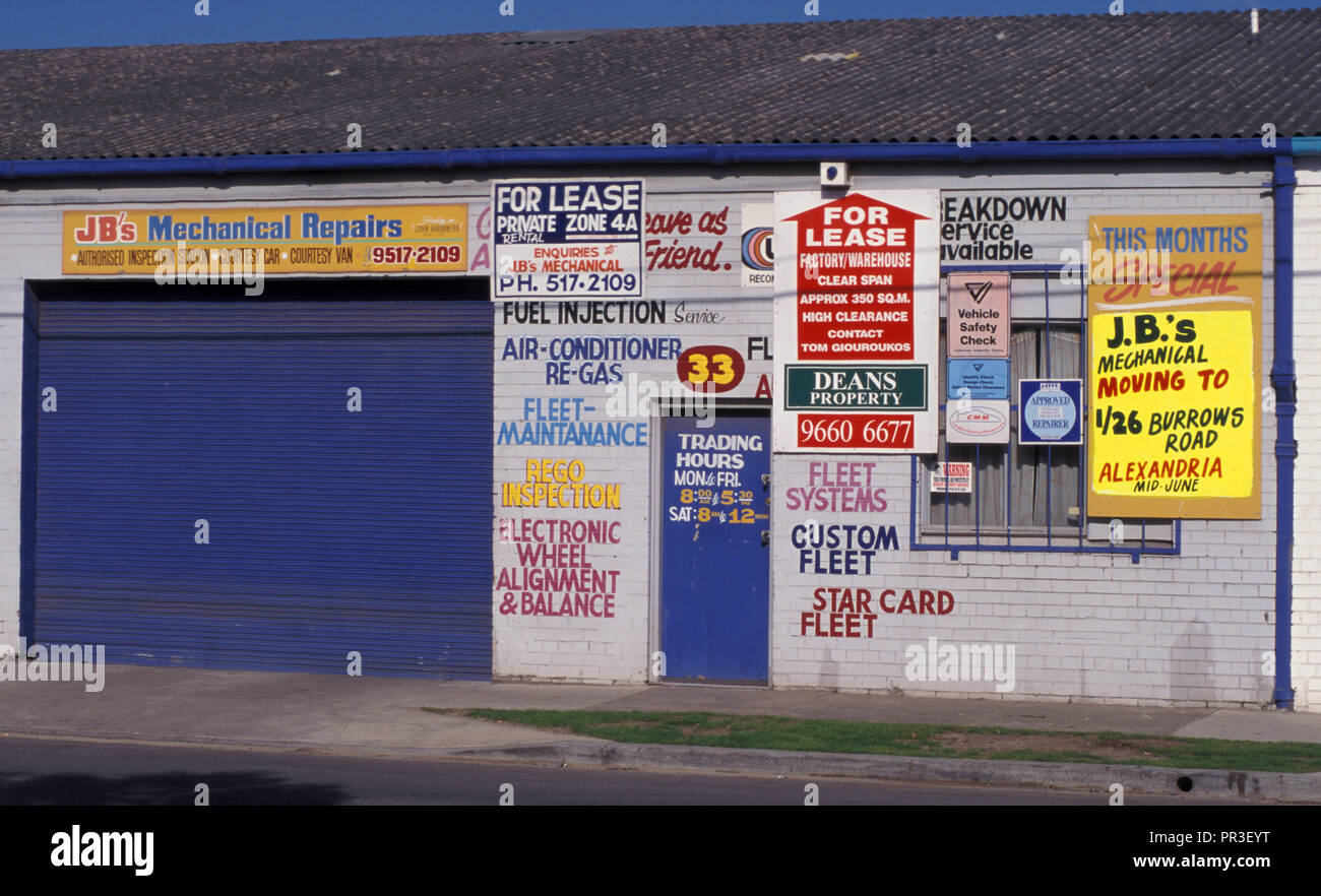 'FOR LEASE' AND ASSORTED SIGNS ON A BUILDING ONCE USED AS A GARAGE