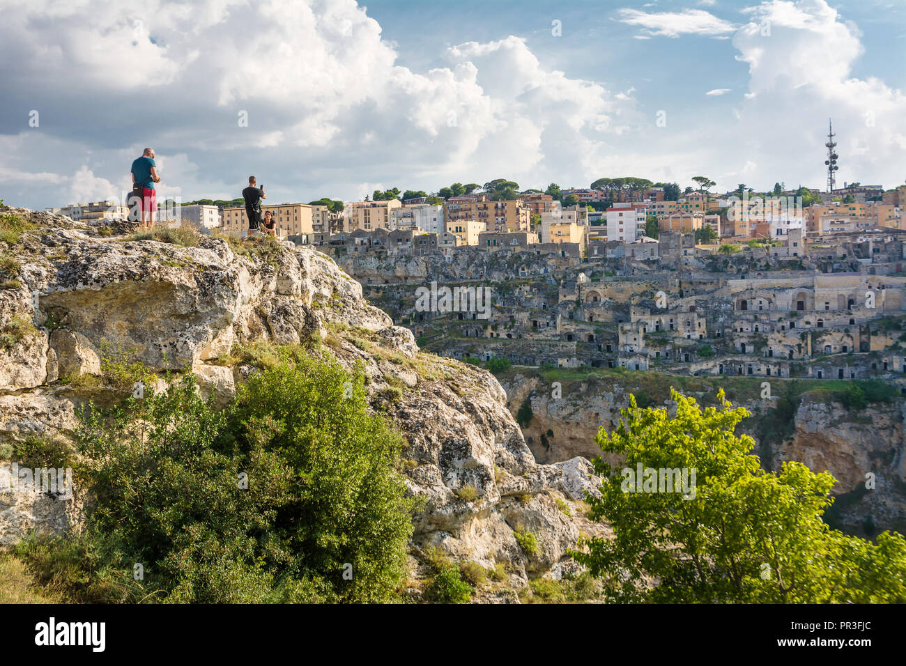 Matera, Italy - August 18, 2018: Tourists watching the Sassi di Matera from the opposite hill Stock Photo
