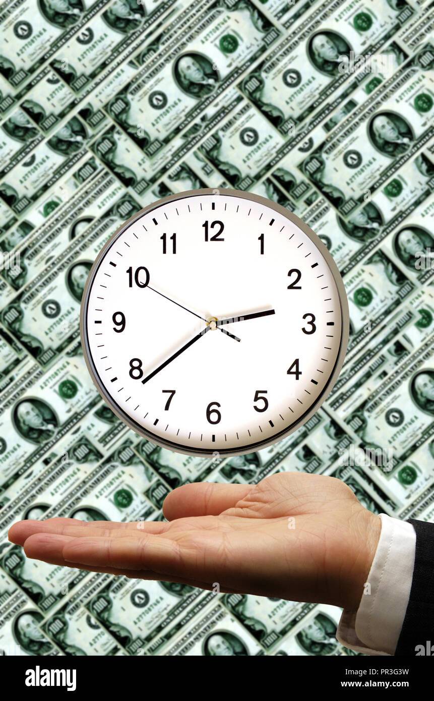 man hand holding a clock over dollar banknotes background, time is ...