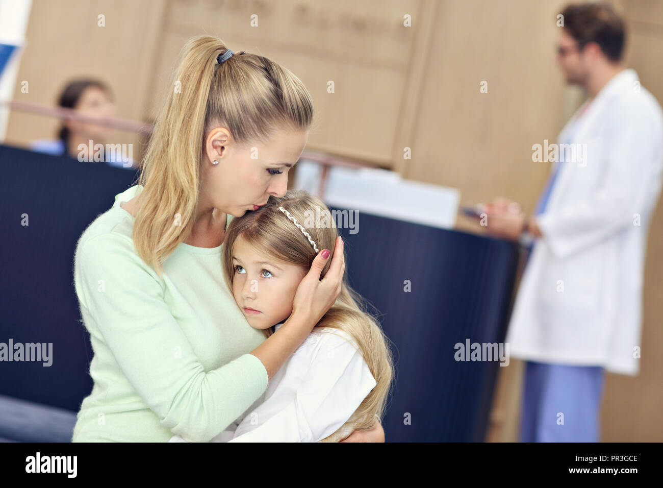 Little girl is crying while with her mother at a doctor on consultation Stock Photo