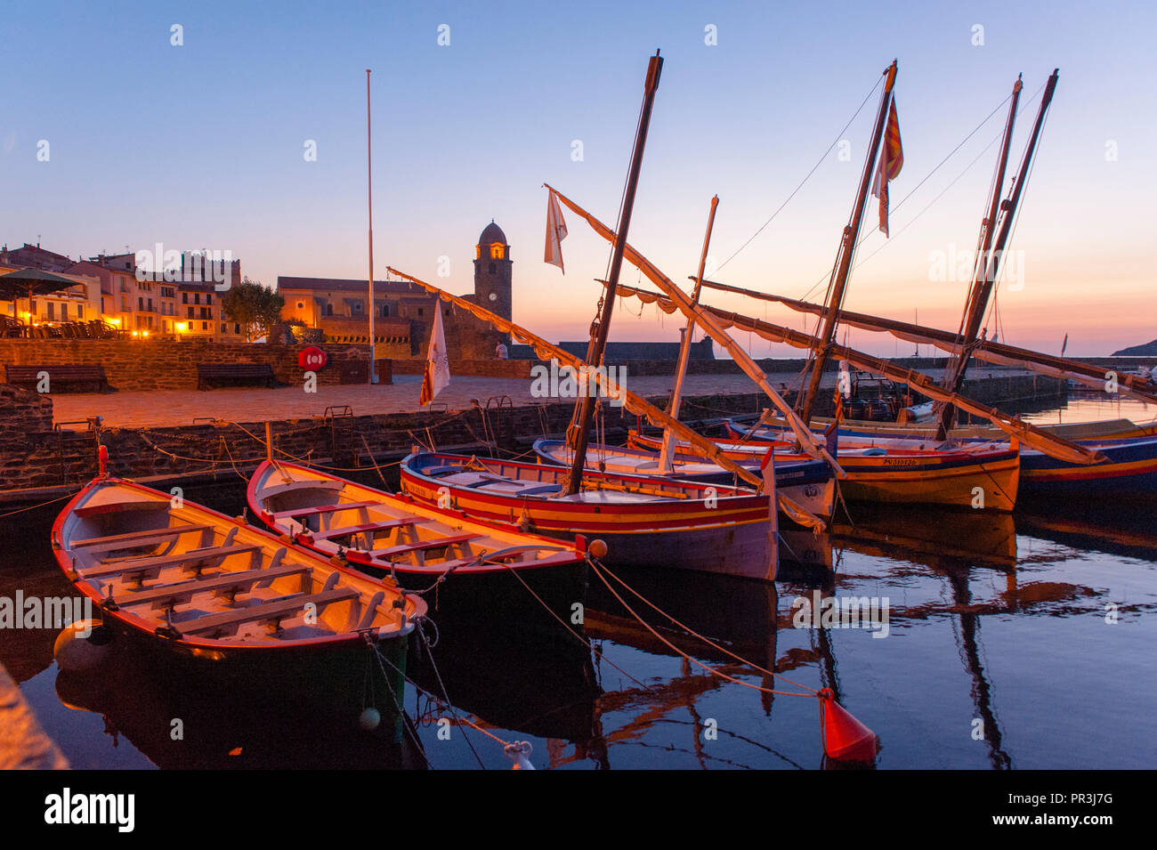 Traditional Catalan boats are moored in the port of Collioure, seen in the early morning light Stock Photo