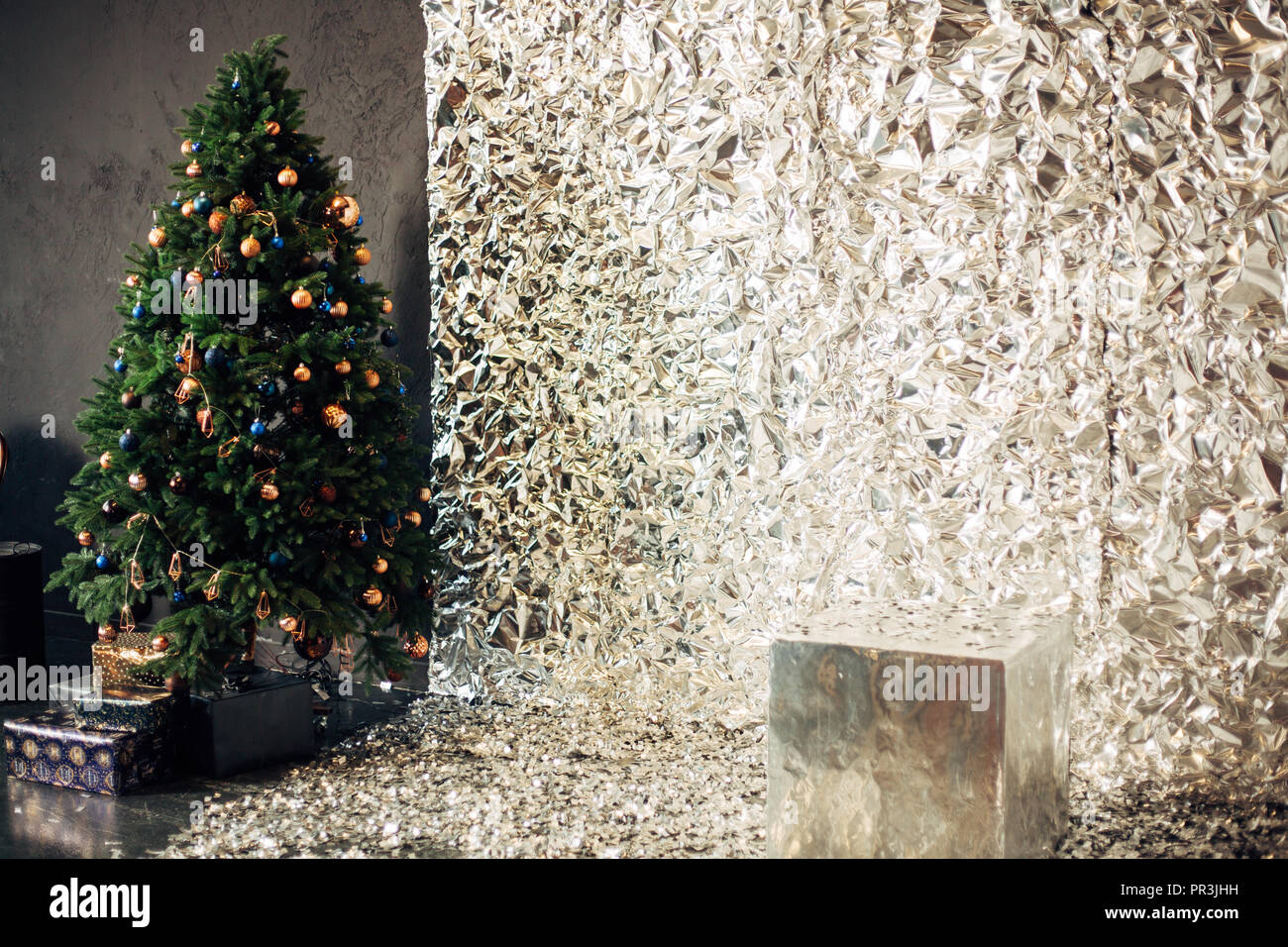 christmas tree with colorful balls and gift boxes over white silver ...
