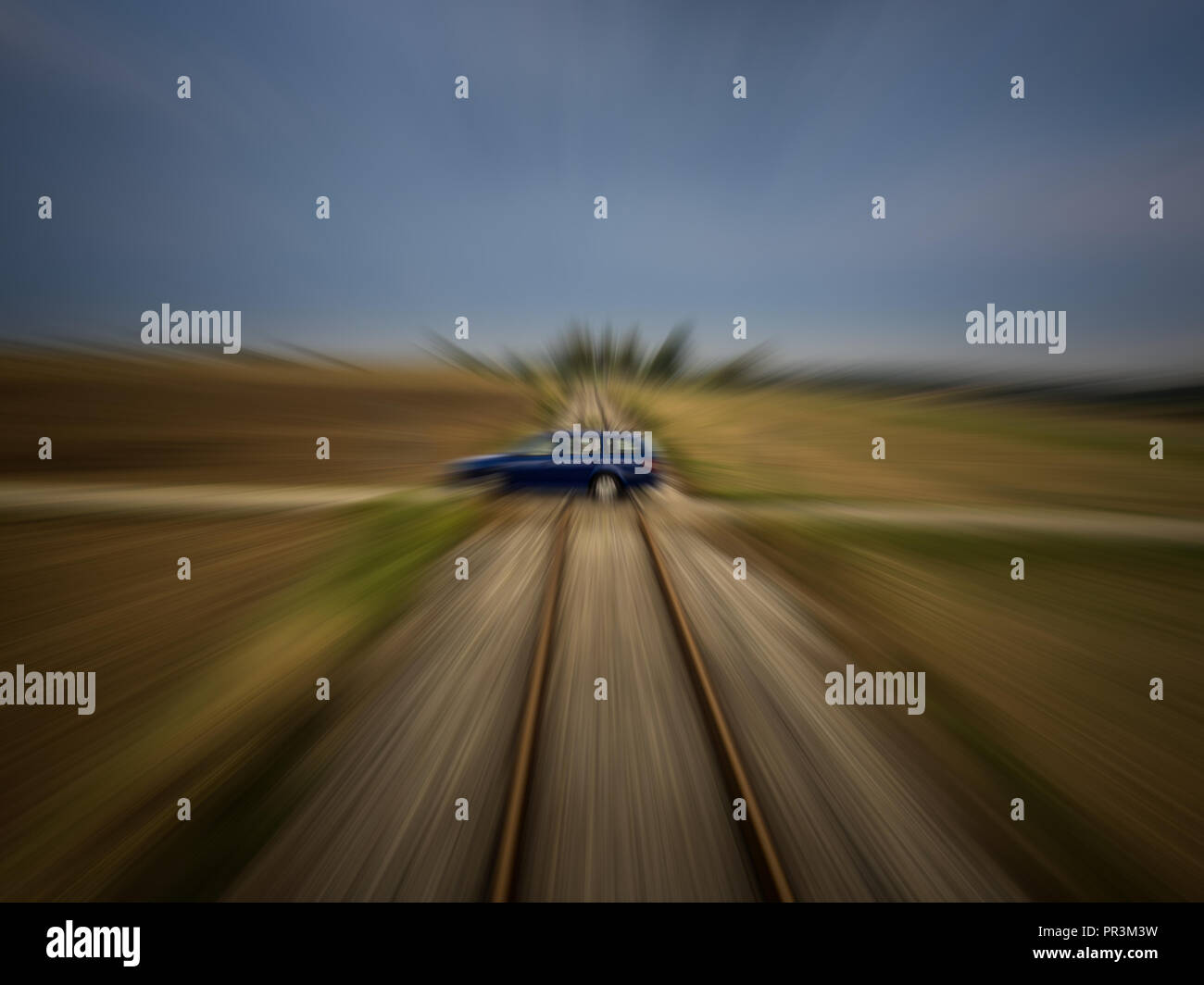 Train perspective of a car passing a railroad crossing with strong motion blur Stock Photo