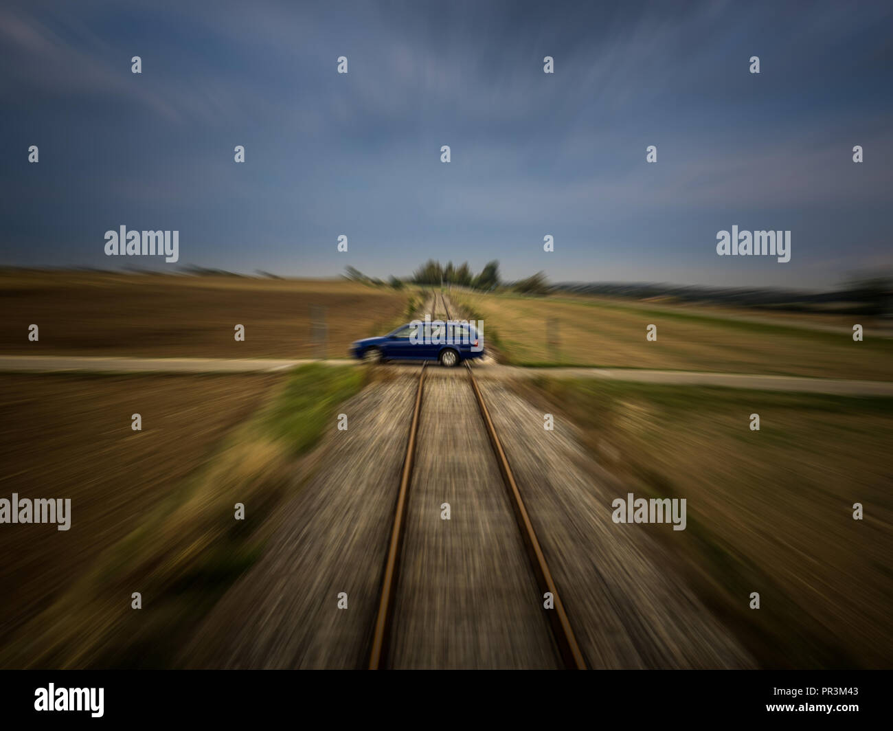 Train perspective of a car passing a railroad crossing with medium motion blur Stock Photo