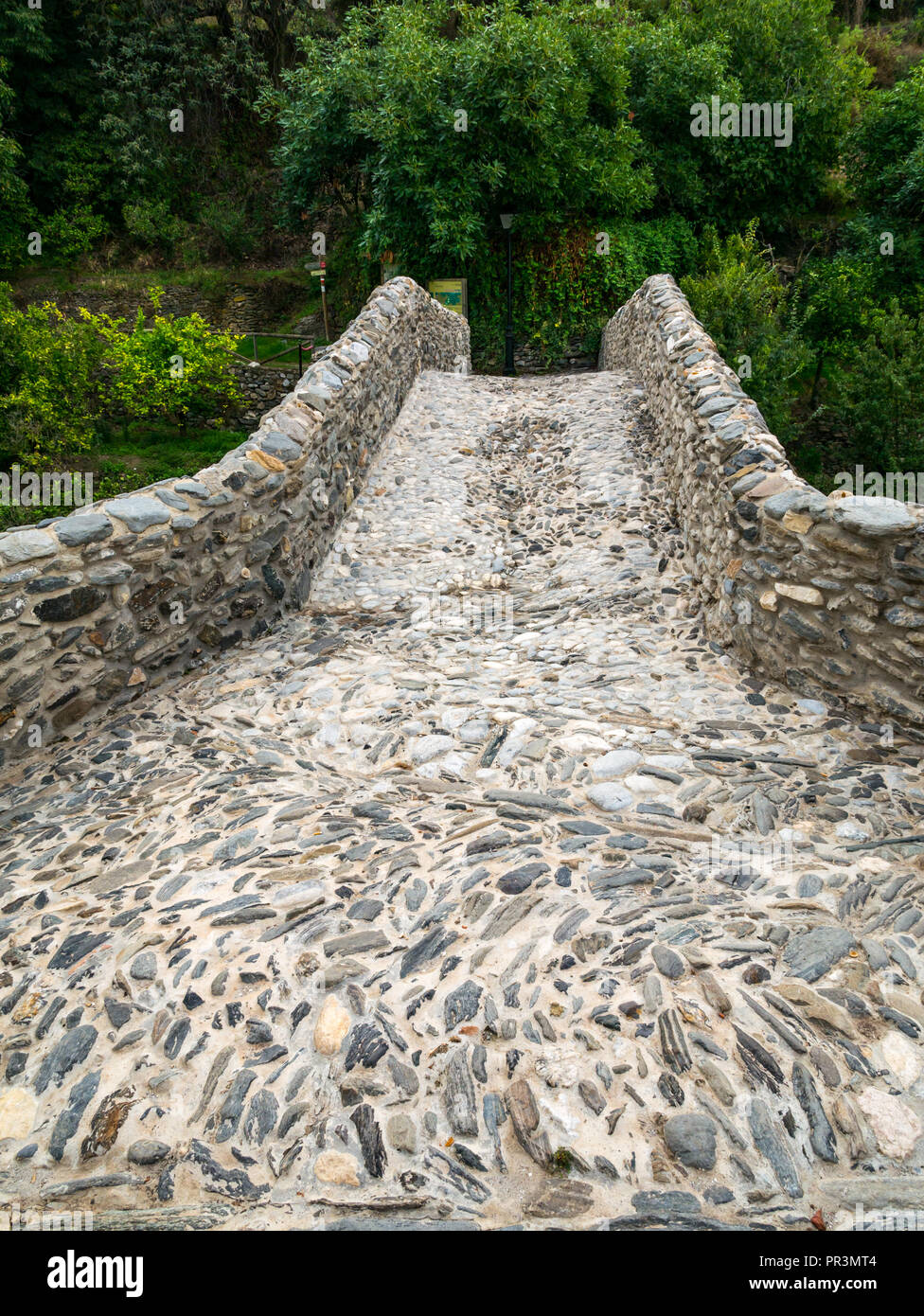 Old cobbled  'Roman bridge' in Mudejar route mountain village, Salares, Axarquia, Andalusia, Spain Stock Photo