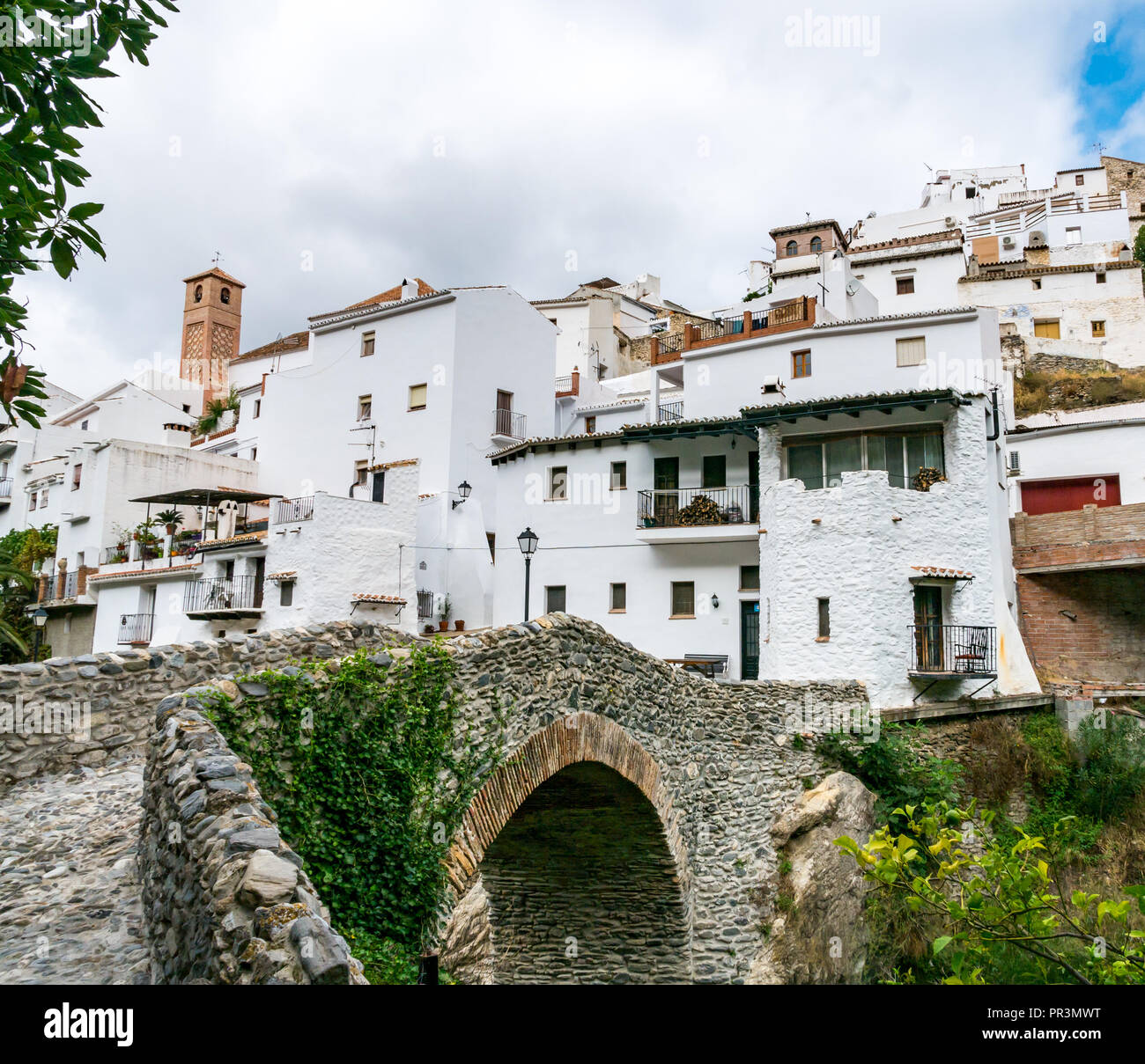 White houses and old Roman bridge in Mudejar route mountain village, Salares, Axarquia, Andalusia, Spain Stock Photo